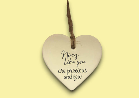 a heart shaped ceramic ornament with a message