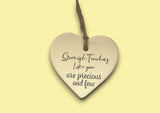 a heart shaped ceramic ornament with a saying on it
