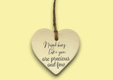 a ceramic heart hanging on a string
